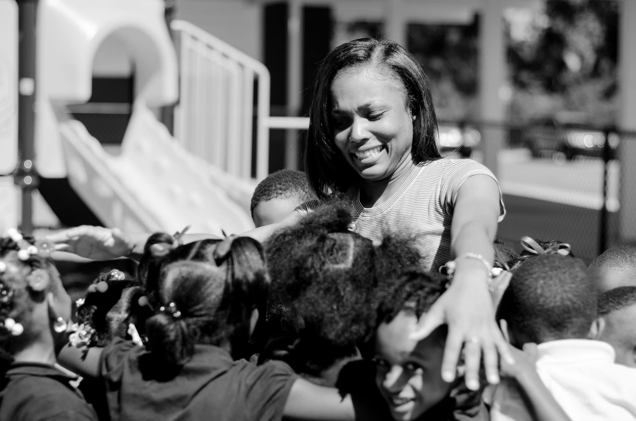 Eboni P. with children on a playground